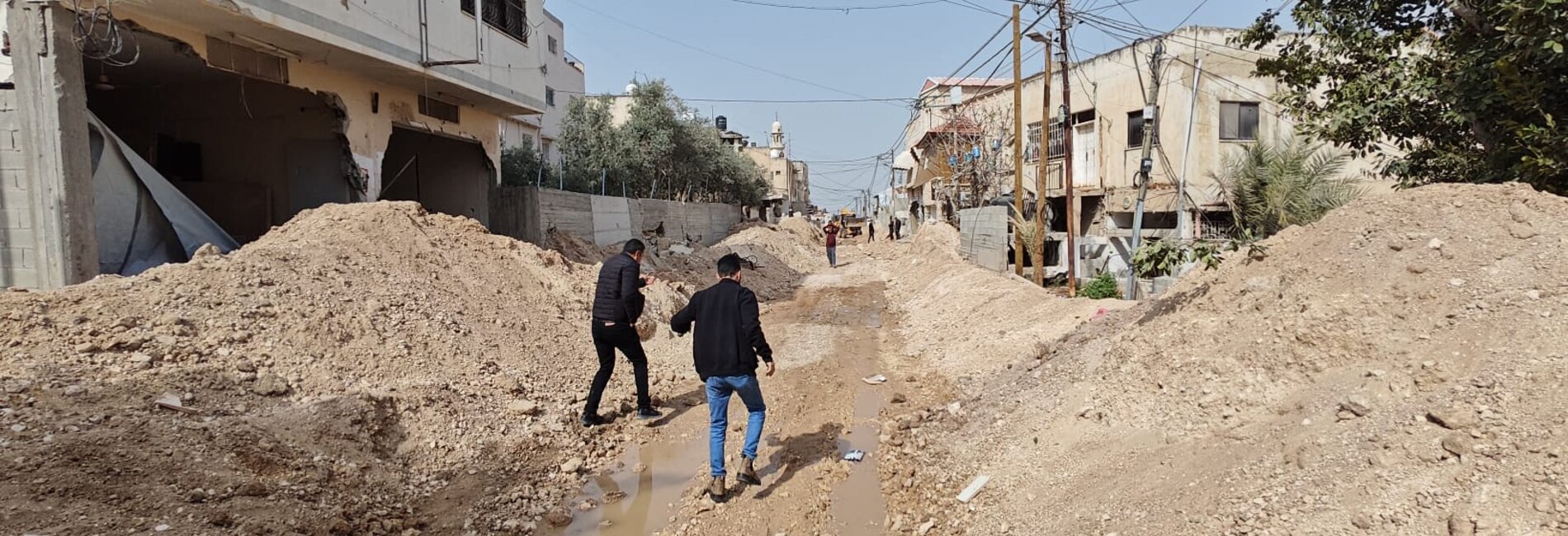 People walking through an area of Jenin city, near Jenin Camp, destroyed by Israeli forces. Photo courtesy of the Jenin Municipality. 