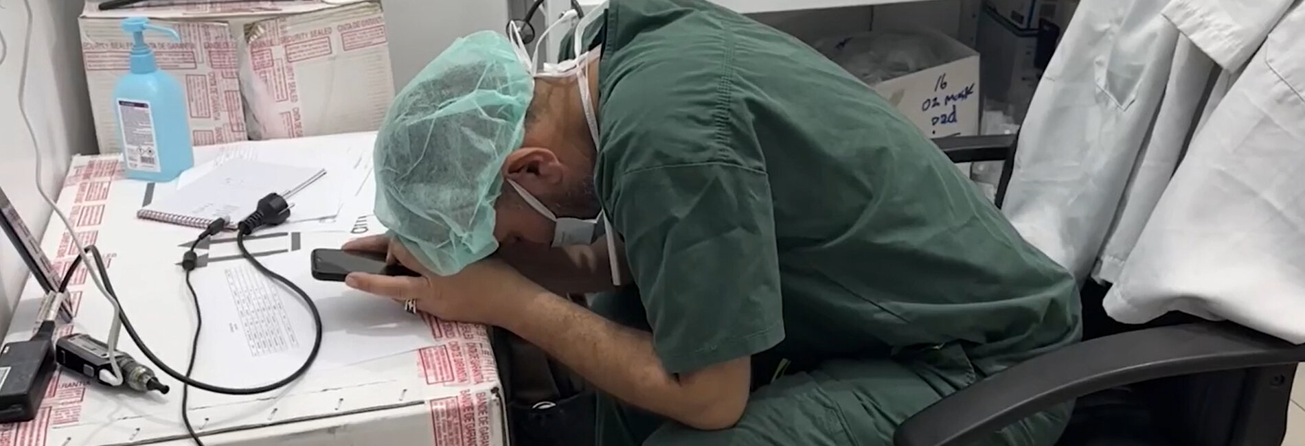 An overwhelmed medical worker in Gaza rests his head in his hands. Photo by Médecins Sans Frontières