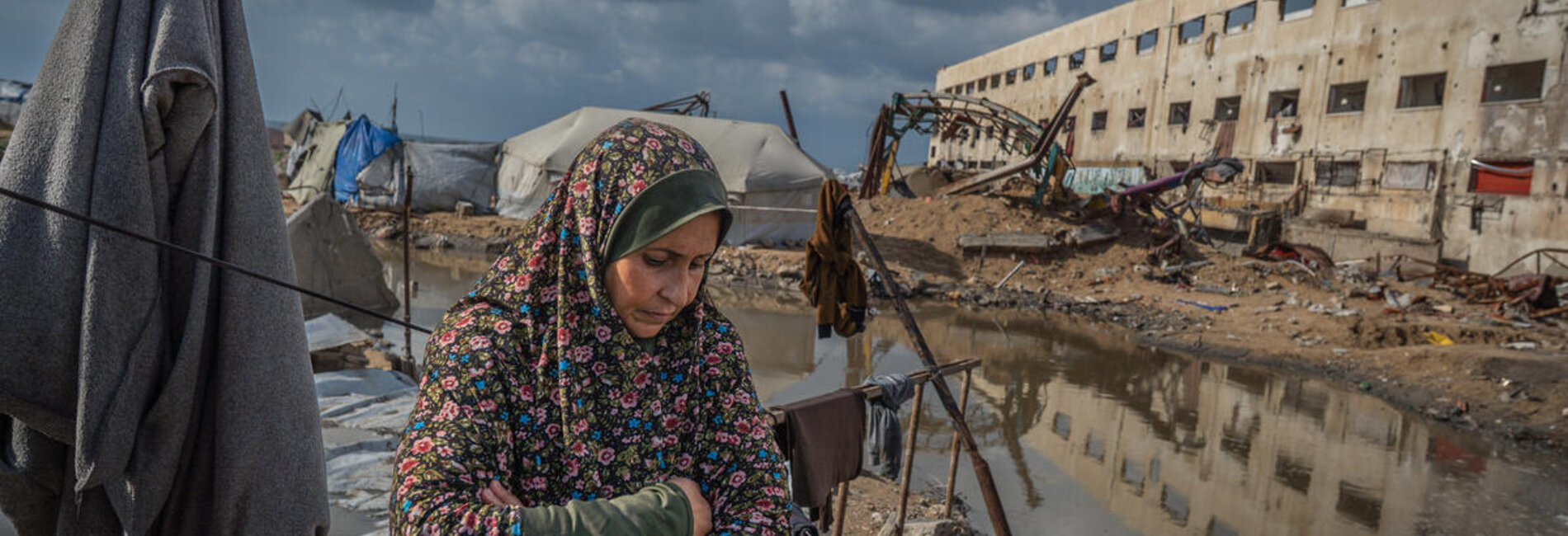 Najat stands outside of her tent in Gaza city, which was flooded after a sewage system nearby overflooded due to heavy rain. Photo by WFP/Maxime Le Lijour 