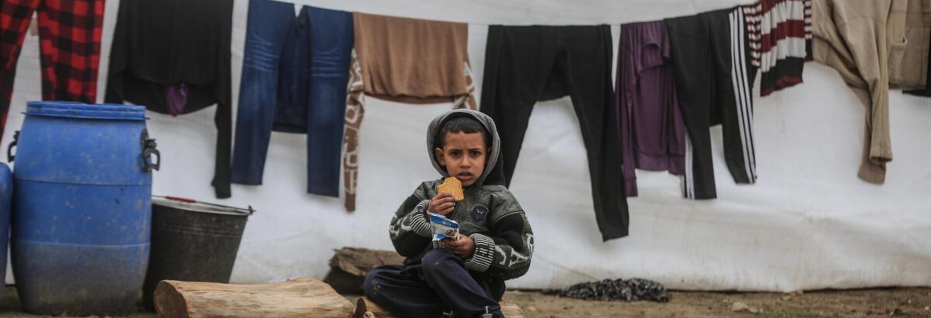 A steep rise in malnutrition is being reported among children and pregnant and breastfeeding women in Gaza, as food and safe water become increasingly scarce and disease proliferates. A boy from a displaced family with a fortified biscuit provided as humanitarian assistance in southern Gaza. Photo by WFP/Ali Jadallahhun