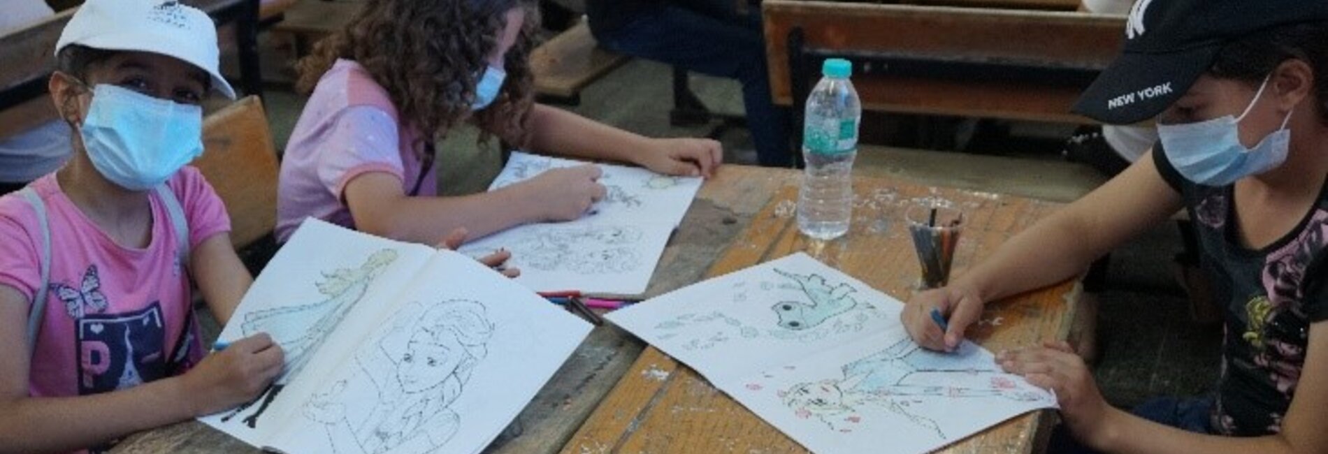 Girls participating in the drawing corner. 5 July 2021. Photo by OCHA.