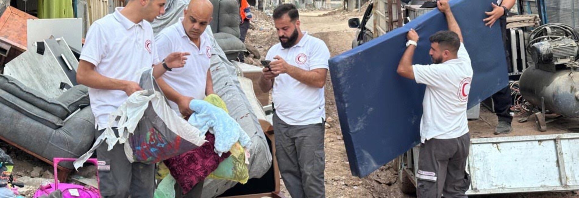 Volunteers from the Palestine Red Crescent Society assist residents of Tulkarm Camp in retrieving belongings from their homes ahead of their announced demolition by Israeli forces. Photo by PRCS