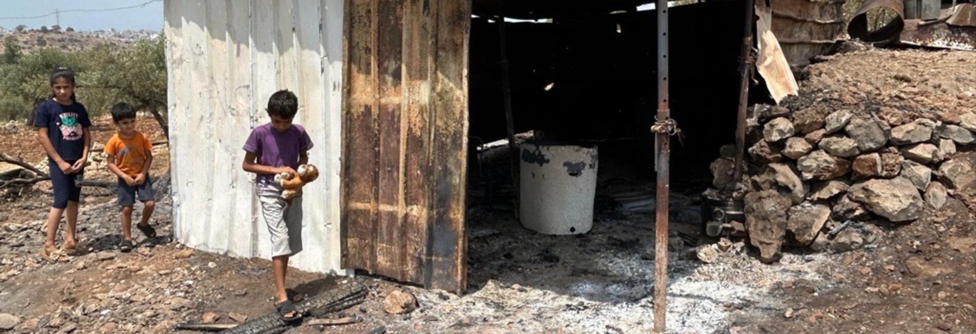 Palestinian children in the West Bank village of Az Zawiya in Salfit governorate following an arson attack carried out by Israeli settlers. Photo by OCHA