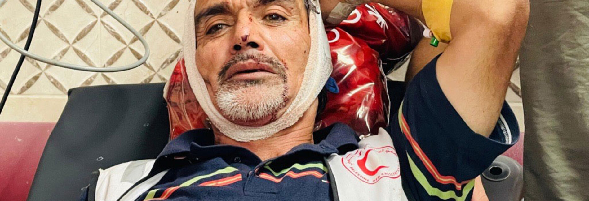 A volunteer with the Palestine Red Crescent Society receives medical treatment after being injured by Israeli settlers who attacked olive harvesters in Beita, Nablus, 8 November 2025. Photo by journalist Abdullah Bahesh