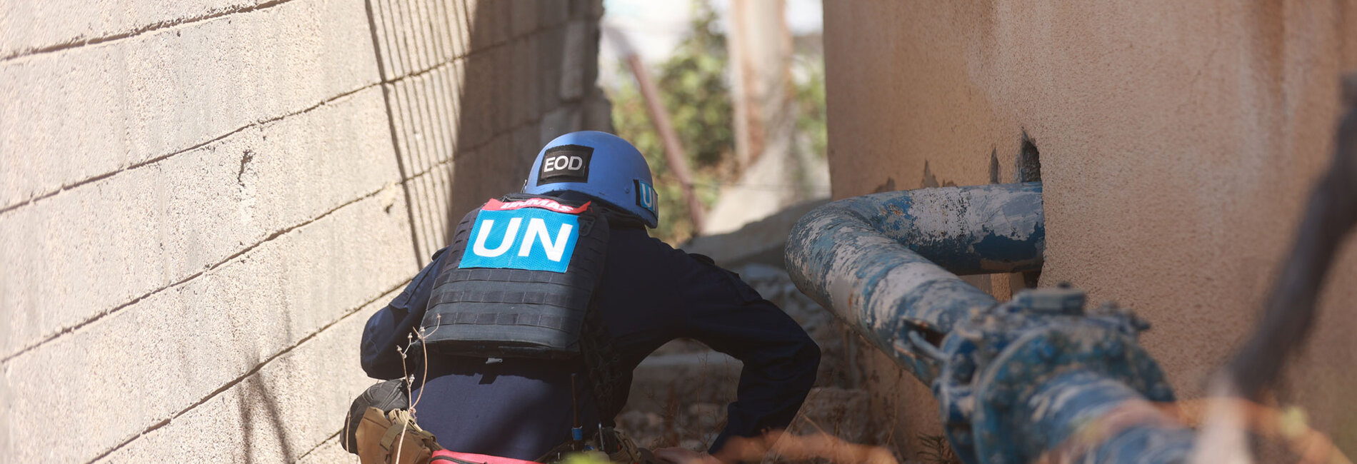 A Mine Action specialist inspects a water well compound in Khan Younis for potential explosive hazards following the ceasefire, in support of humanitarian and recovery efforts, 19 October 2025. Photo by UNMAS 
