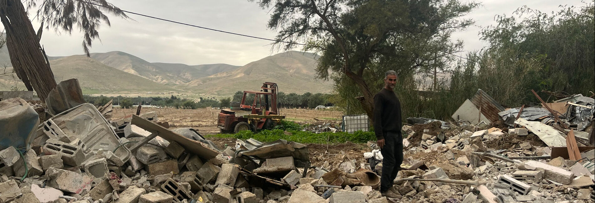 A Palestinian resident of Al Jiftlik-Abu al 'Ajaj, in Jericho governorate, following the demolition of his home for lacking building permits that are nearly impossible for Palestinians to obtain, 21 January 2025. Photo by OCHA