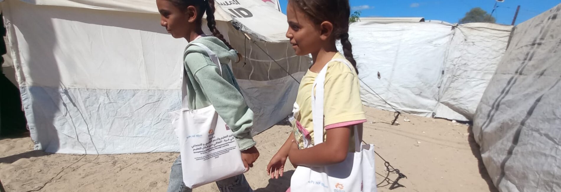 Displaced girls in southern Gaza walking from a temporary learning space they attend in Khan Younis, through funding by the occupied Palestinian territory Humanitarian Fund. Photo by War Child Holland 