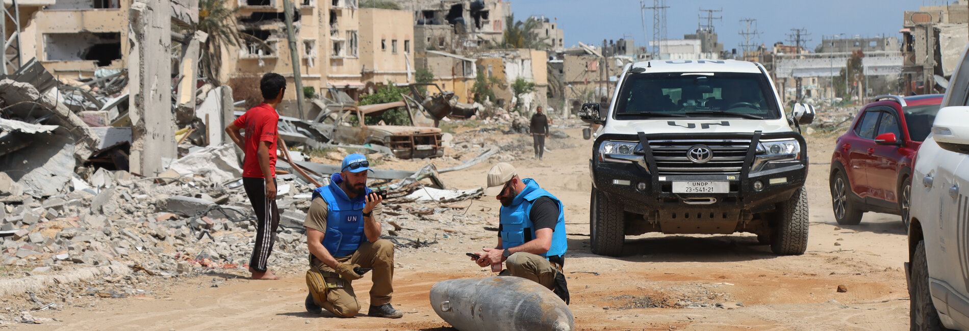 UN specialists inspect unexploded ordnance following the withdrawal of Israeli troops from Khan Younis city, on 10 April 2024. Photo by OCHA/Themba Linden