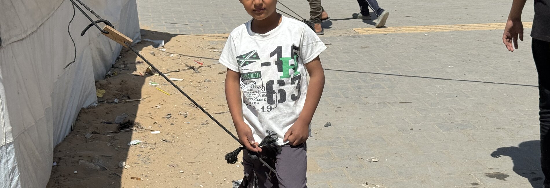 A Palestinian boy in a site for displaced people in Gaza city. Photo by OCHA/Olga Cherevko    