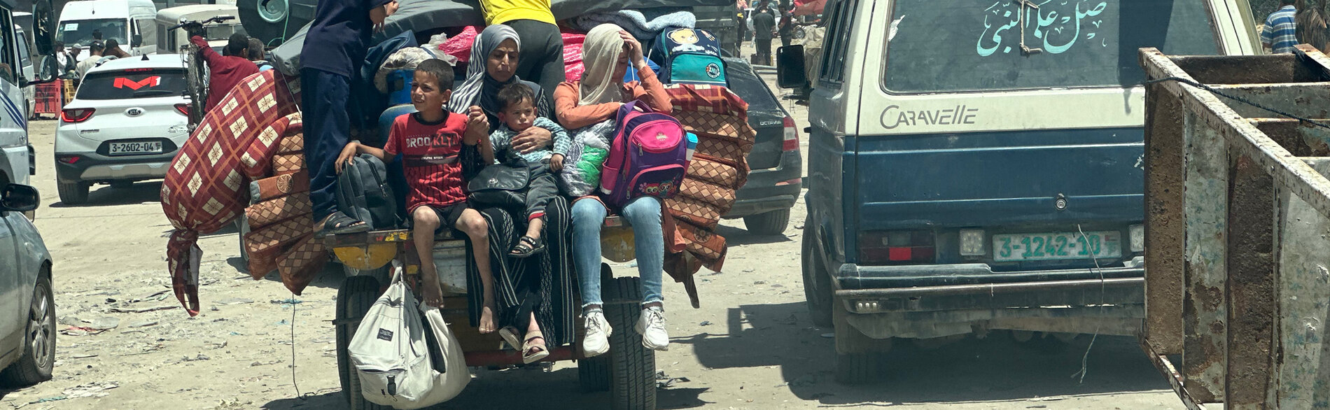 Families leaving Rafah on 7 May 2024 following an evacuation order by the Israeli authorities. Photo by OCHA/Olga Cherevko