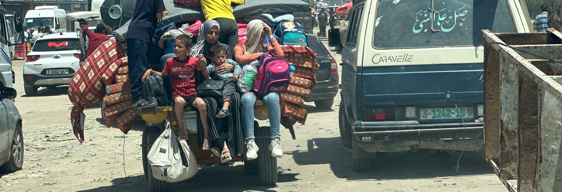 Families leaving Rafah on 7 May 2024 following an evacuation order by the Israeli authorities. Photo by OCHA/Olga Cherevko