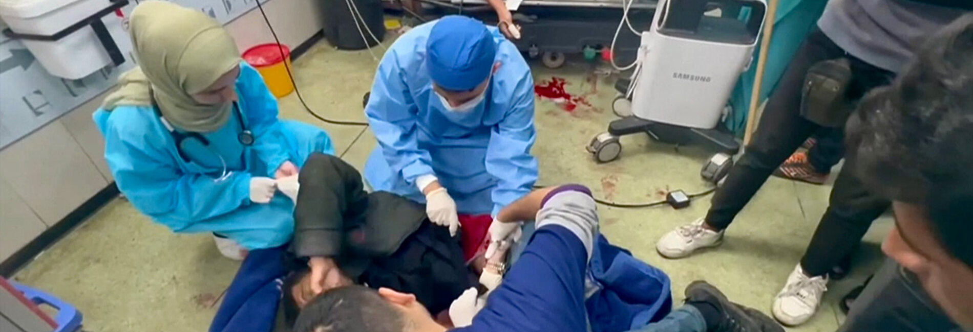 Medical team treating trauma injuries on the floor in Nasser hospital, Khan Younis. Screenshot from a video by WHO, January 2024 