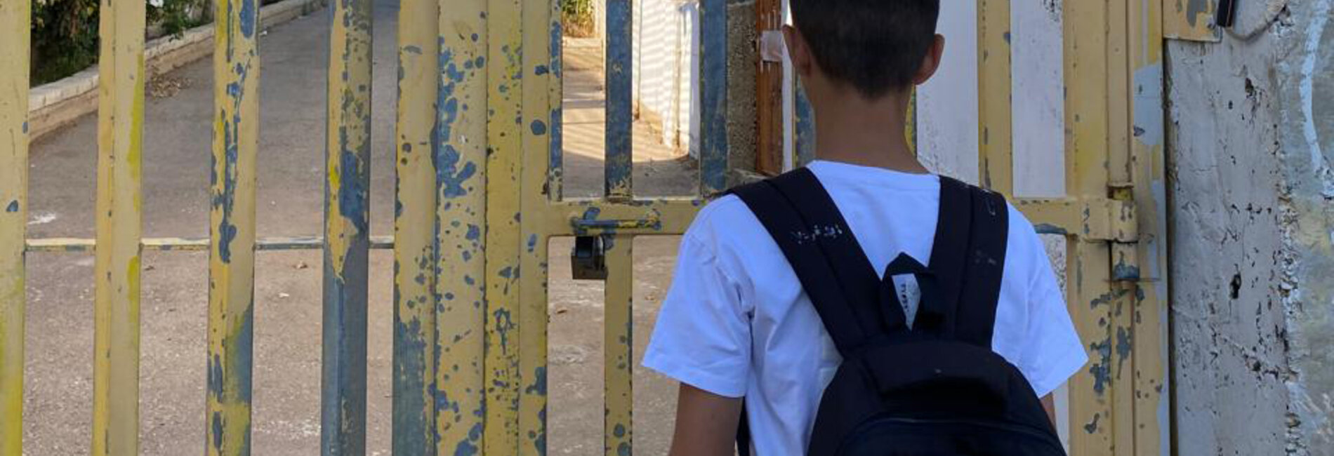 The son of Saadat Gharib standing in front of a gate installed by the Israeli military. The gate controls access to his family’s home, now encircled by settlement infrastructure. Photo by Shafea Jalamneh / Médecins du Monde Spain, Beit Ijza, East Jerusalem.