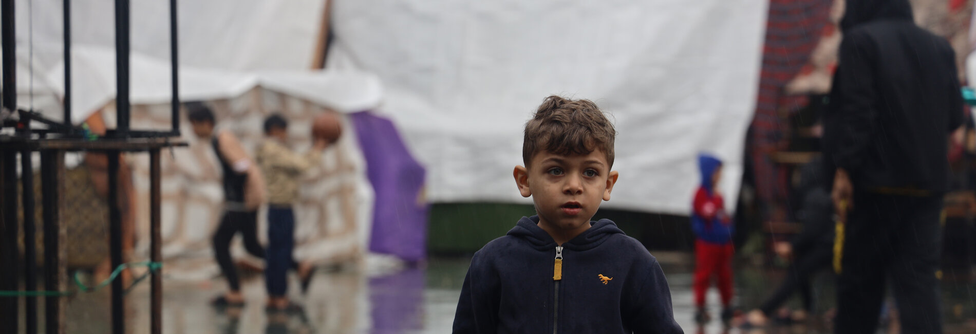 A 6-year-old displaced boy in southern Gaza, where heavy rains have worsened the already dreadful living conditions of people staying outdoors, adding to the risk of waterborne diseases. Photo by UNICEF/El-Baba, 6 December 2023