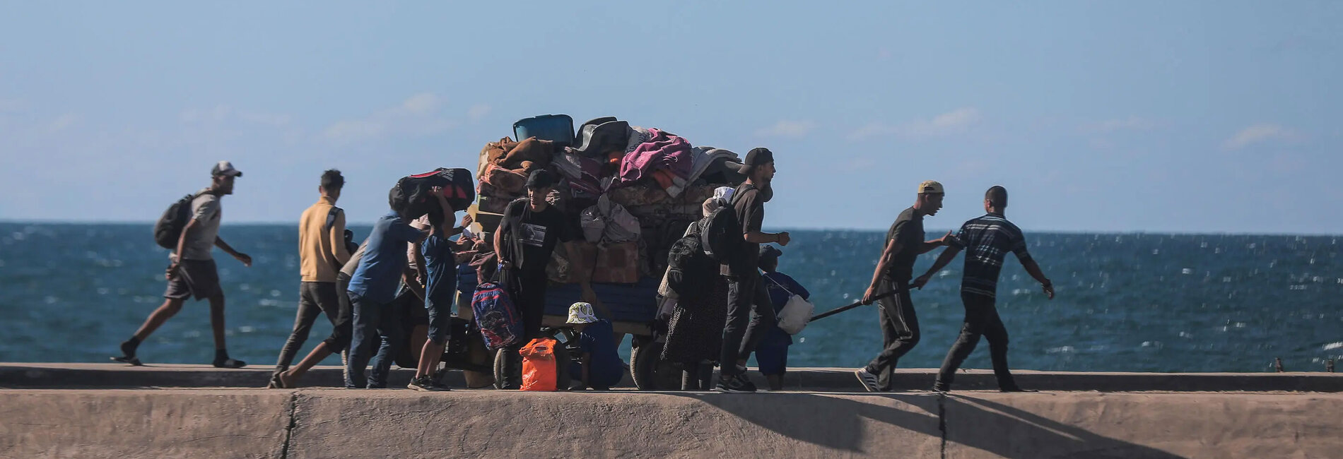 On 10 October 2025, families make their way along Gaza’s coastal road toward the north, returning home through areas devastated by months of conflict. Photo: UNICEF/UNI876888/Nateel