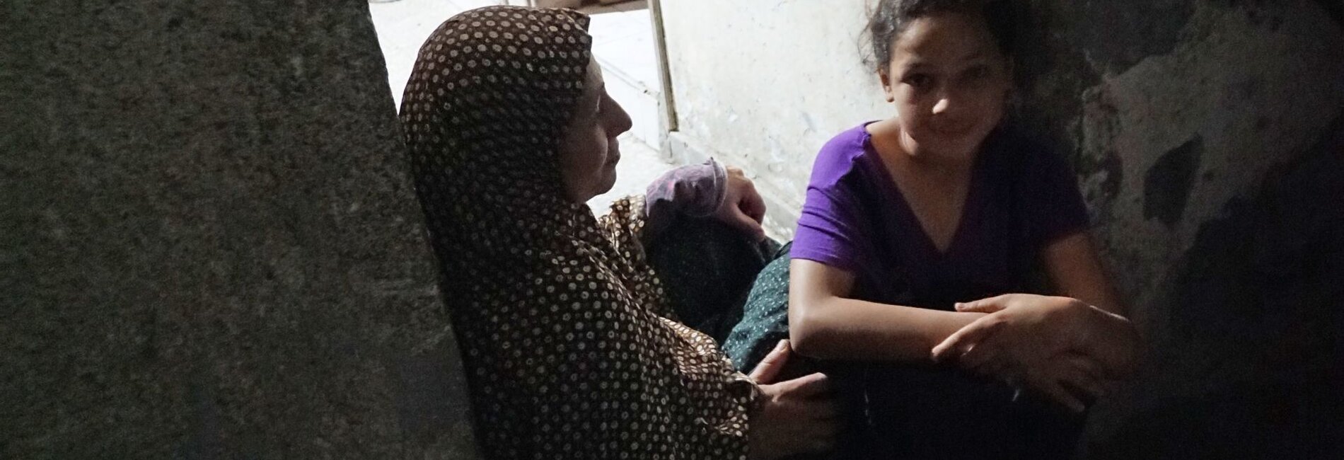 Abeer al Nemnem and her daughters sitting at the porch of their house in Ash Shati Refugee Camp, Gaza, May 2017. ©  Photo by OCHA.