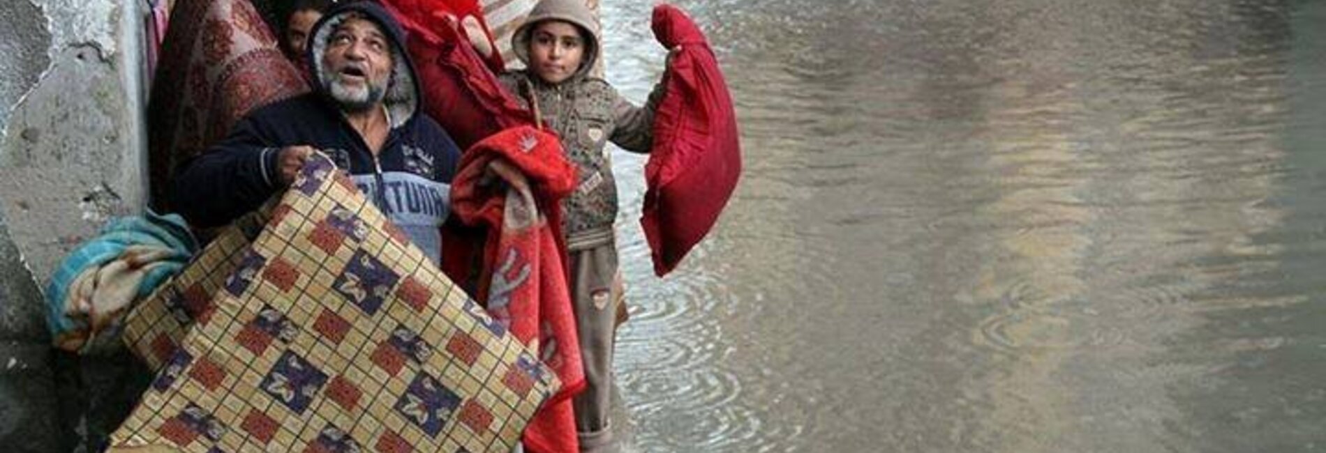 Family evacuating their home in Gaza, 12 December 2013