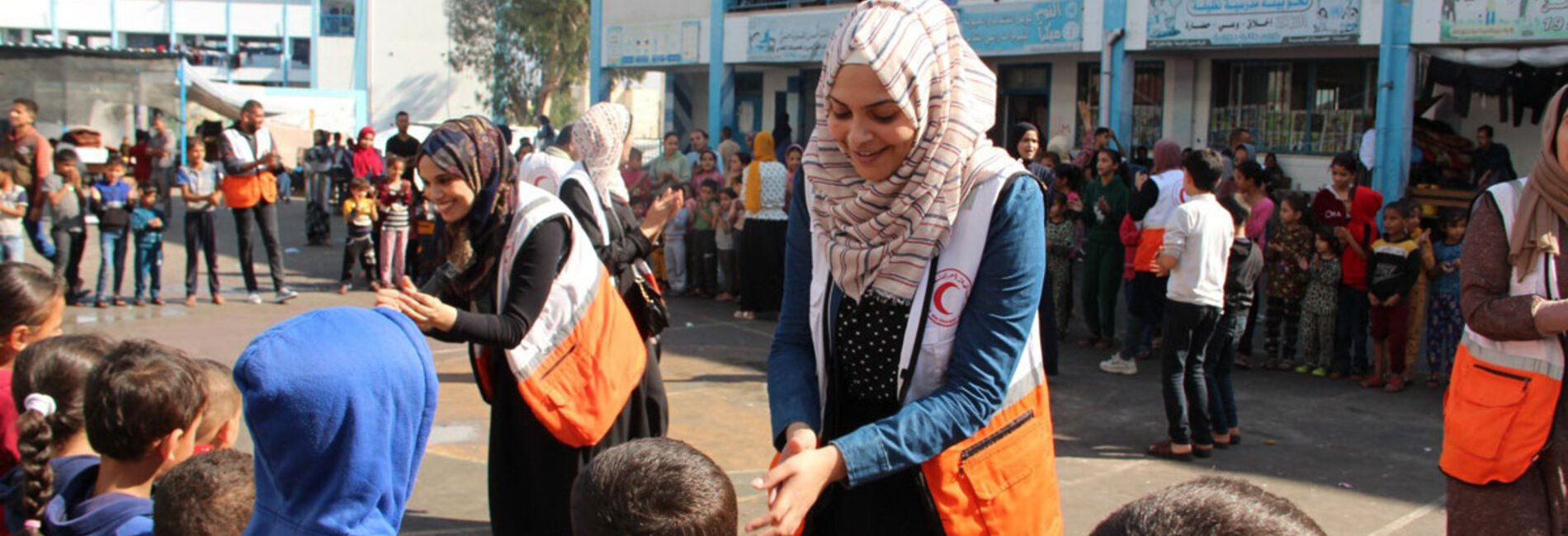 Volunteers providing psycho-social support to children in southern Gaza through recreational activities in a school being used as a shelter for displaced people. Photo by the Palestine Red Crescent Society 