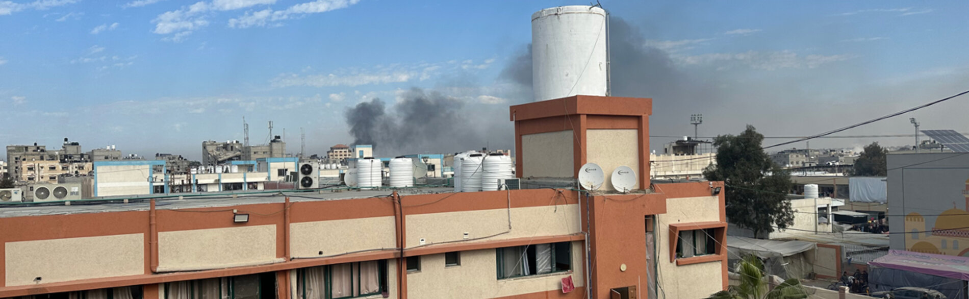 Smoke seen in a picture taken from the office of the director of Nasser hospital. This is one of three hospitals in Khan Younis, around which heavy fighting has taken place in recent days. Medical teams have reportedly been unable to transfer serious injuries from the hospital to nearby facilities. Photo by OCHA/Olga Cherevko, 21 January 2024
