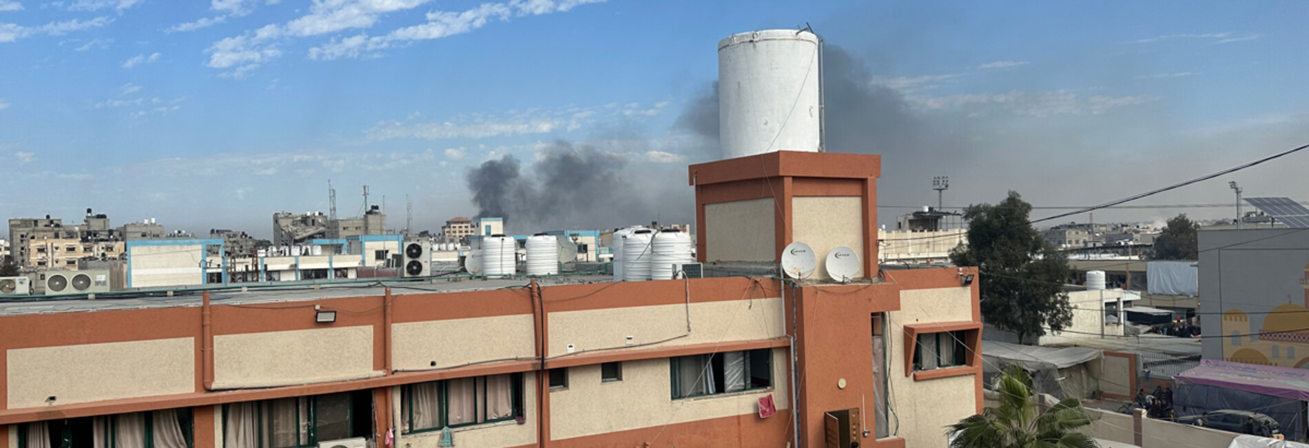 Smoke seen in a picture taken from the office of the director of Nasser hospital. This is one of three hospitals in Khan Younis, around which heavy fighting has taken place in recent days. Medical teams have reportedly been unable to transfer serious injuries from the hospital to nearby facilities. Photo by OCHA/Olga Cherevko, 21 January 2024