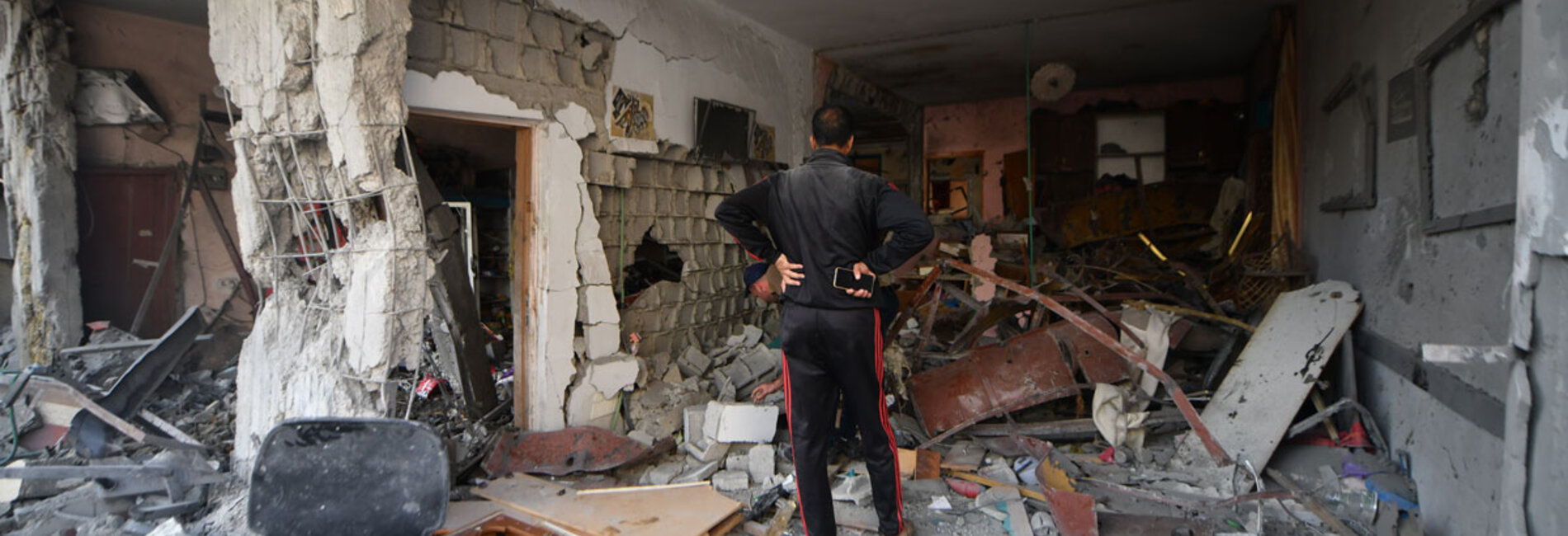 Jamal inspects his home in Khan Younis, in the southern Gaza Strip, after it was heavily damaged in hostilities. By 6 November, over 40,000 housing units across the Gaza Strip had been destroyed, according to the Ministry of Public Works and Housing. Photo by ©UNICEF/Zaqout, 16 November 2023