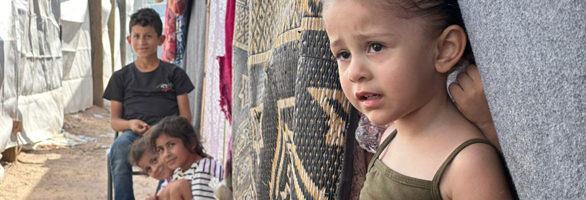 Displaced children staying at the Khan Younis Training Centre, the most overcrowded UN shelter in Gaza. With less than two square metres per person, many of the 22,000 displaced people at this facility stay outdoors. Photo by UNRWA