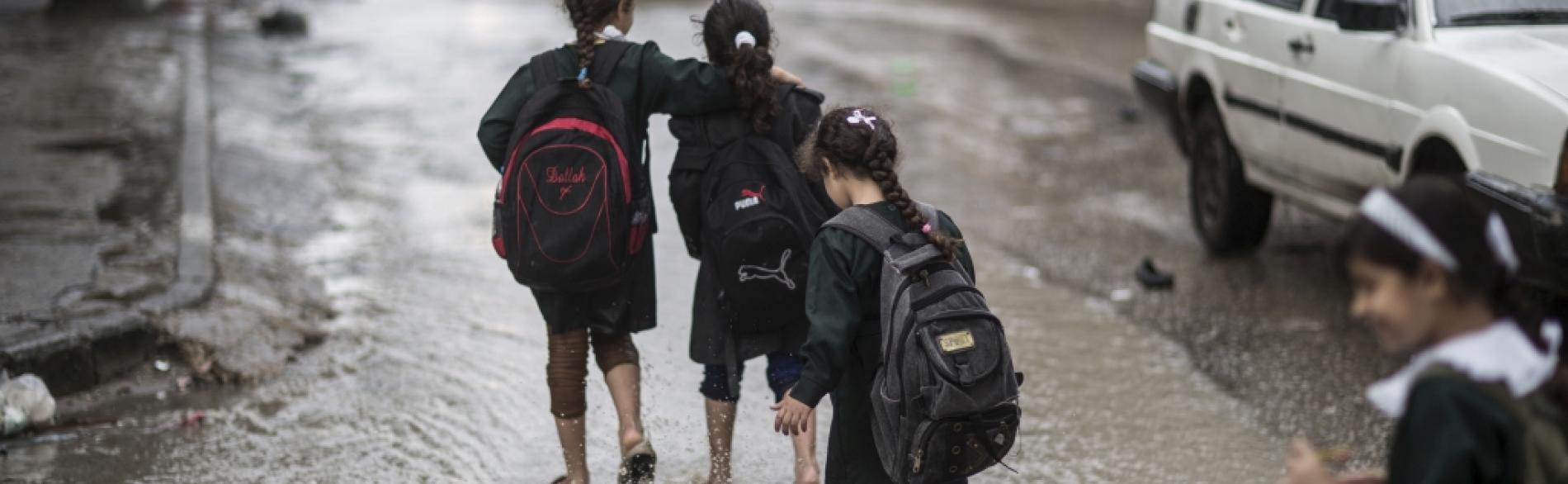 Children on their way back from school, during floods in Gaza city, January 2015. © Photo by Wissam Nassar