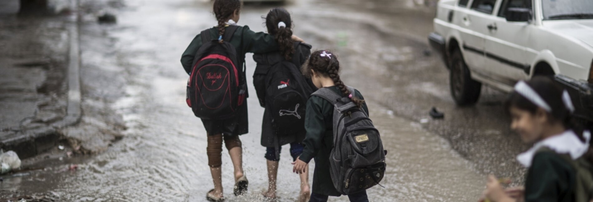 Children on their way back from school, during floods in Gaza city, January 2015. © Photo by Wissam Nassar