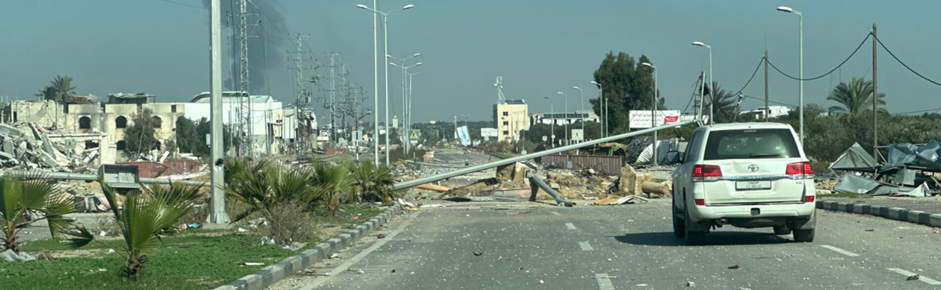 Damaged roads and intense hostilities are among the challenges faced by humanitarian workers struggling to support people in need across Gaza. A United Nations car driving on a damaged road in Deir al Balah. Photo by OCHA/Olga Cherevko, 18 January 2024 