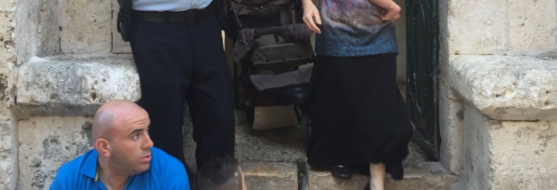 Settler family leaving Palestinian evicted property in East Jerualsem, shortly after taking it over on 15 September 2016. Photo by OCHA