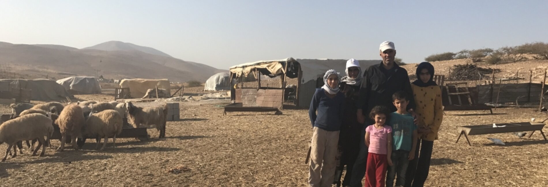 Bisharat family, standing in front of their residence which is at imminent threat of demolition, Makhul, 18 October 2017. © Photo by OCHA