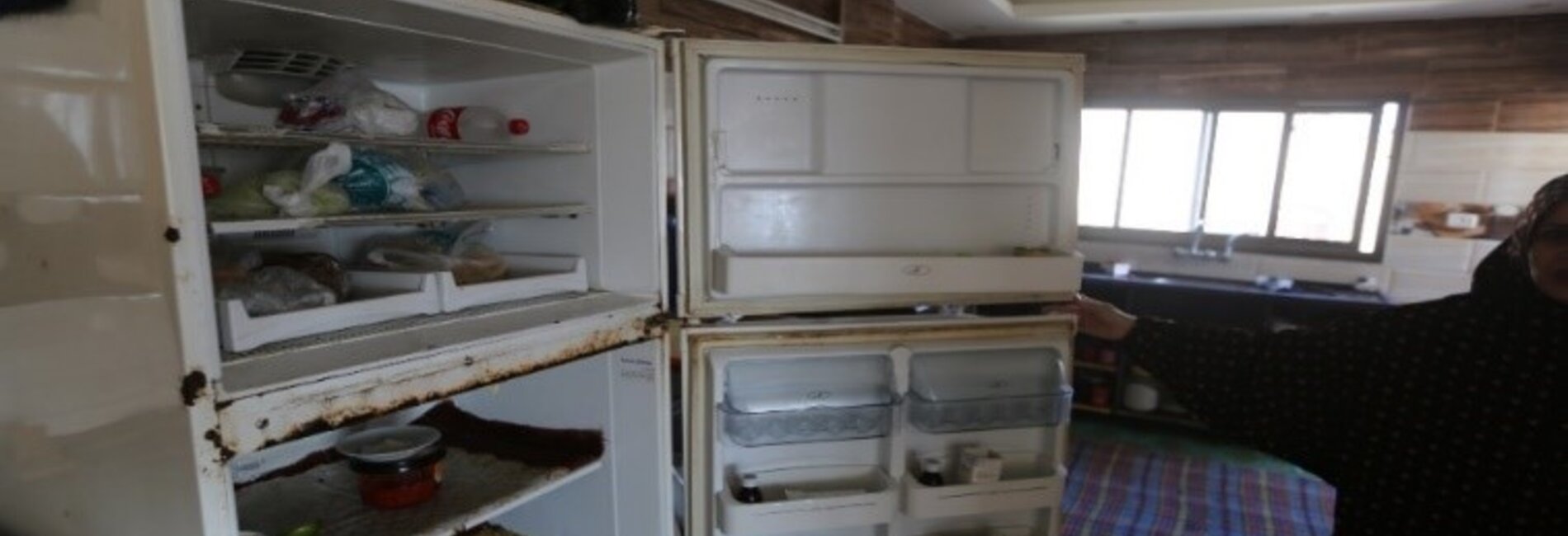 Sabreen shows her empty fridge. 3 December 2020, Gaza City. Photo by GPC