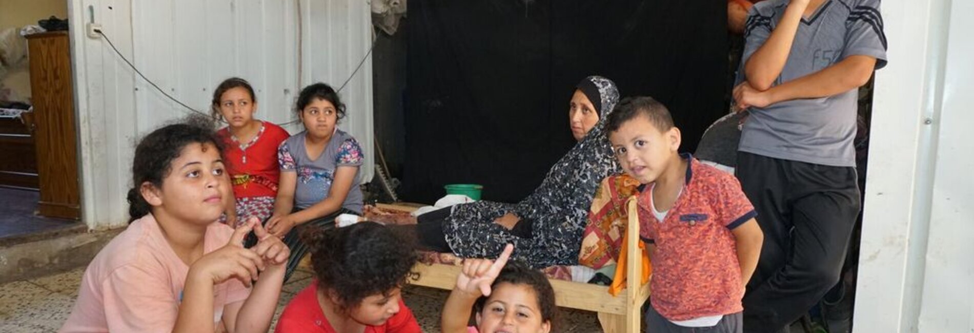 Khader’s family, in their caravan which they have lived in since October 2014, Beit Hanoun, August 2017. © Photo by OCHA