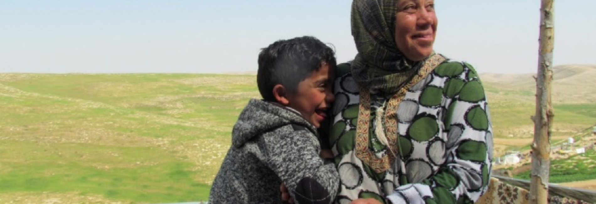 Shifaa Abu Iram and her son sitting in Halaweh community, Massafer Yatta (Firing zone 918).  © Photo by OCHA