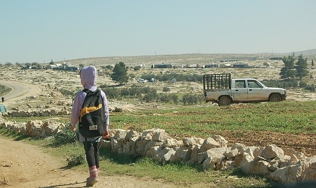 A student facing the Palestinian village of Susiya while walking home from school. Photo by Nanor Arakelian © World Vision 2018.