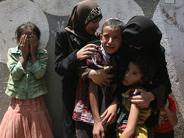 Children in a funeral in Rafah waiting for the bodies of several family members killed in an airstrike, July 15, 2014. Photo: UNICEF/ElBaba