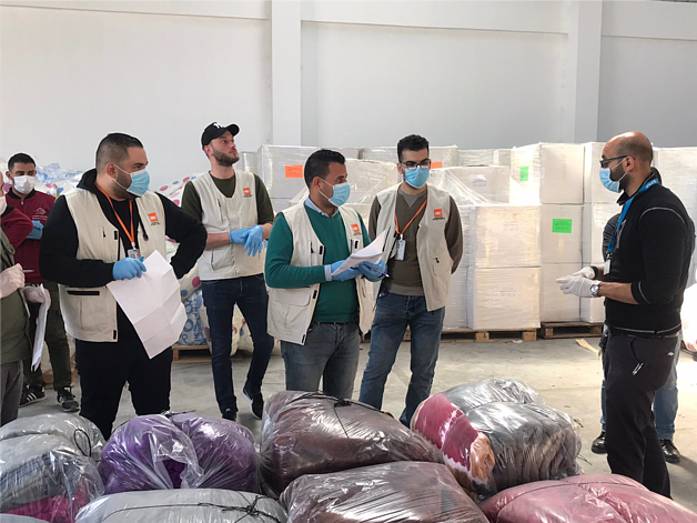Staff of an aid organization preparing for the distribution of bedding sets to isolation centers. April 2020, Rafah. Photo by NRC Staff of an aid organization preparing for the distribution of bedding sets to isolation centers. April 2020, Rafah. Photo by NRC