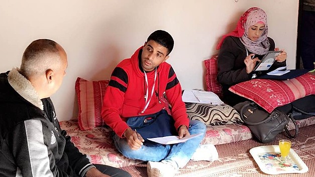 NRC staff interviewing an IDP family in northern Gaza, November 2017.