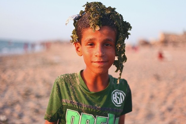 Palestinian boy after swimming in a polluted beach in Deir al Balah Camp, Gaza. © Photo Credit: Rehaf Batniji/OXFAM 2018