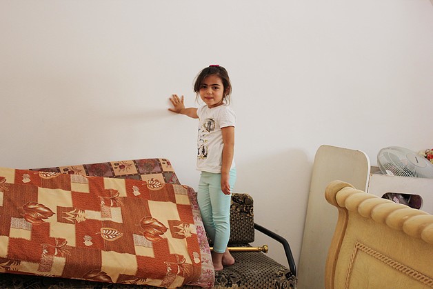 Suhad’s daughter, Muluk (4 years old), standing in her repaired bedroom. Suhad’s daughter, Muluk (4 years old), standing in her repaired bedroom.