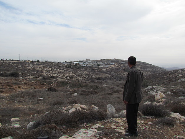 Ahmad Abu Shanab looking at his land near Pnei Kedem outpost, Nov 2014. © Photo by OCHA