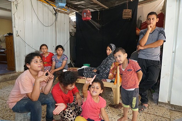 Khader’s family, in their caravan which they have lived in since October 2014, Beit Hanoun, August 2017. © Photo by OCHA