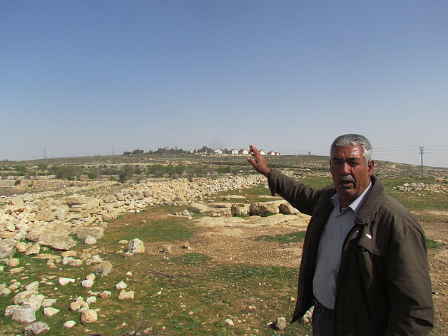 Farmer from Sa’ir pointing at his land next to Asfar settlement