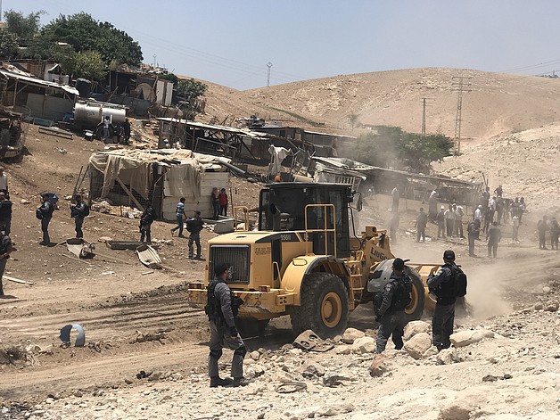 Israeli forces leveling land next to Khan Al Ahmar, in preparation for the demolition of the community, 4 July 2018. © Photo by JFF