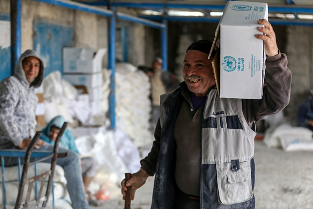 A Palestinian refugee receiving a food basket in the Al Shatti distribution center, Gaza city © 2017 UNRWA Photo by Rushdi Al-Sarraj.