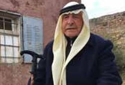 Abed al Huda Shreiteh outside his house which was burned by settlers in 2011 (December 2016)