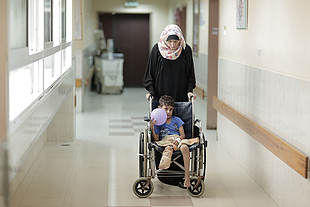 A mother and son in the orthopedic department at Ash Shifa hospital, Gaza City, October 2015