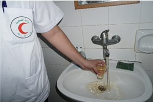 Medical staff showing rusty water available through water network, Al Shifa hospital, Gaza. November 2018