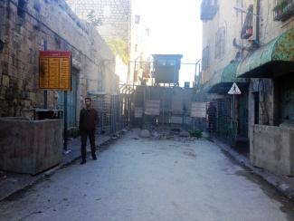 Checkpoint controlling access to the Ash Shuhada street in the heart of Hebron city. Photo by OCHA