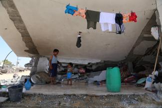 Family residing in a severely damaged home in Johr ad Deek